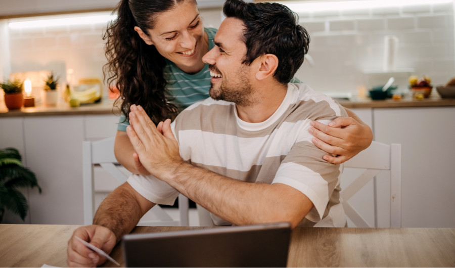 Pareja feliz luego de ver los beneficios de haber contratado Cuota Fija